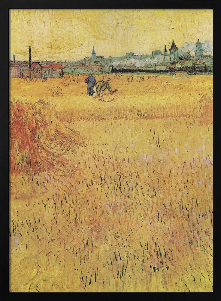 A Post-Impressionist painting by Vincent van Gogh depicting a vast, golden wheat field under a yellow sky. Two figures are harvesting wheat in the middle distance, with a town and industrial buildings on the horizon. The artwork is characterized by thick, textured brushstrokes and is displayed in a black frame. Print