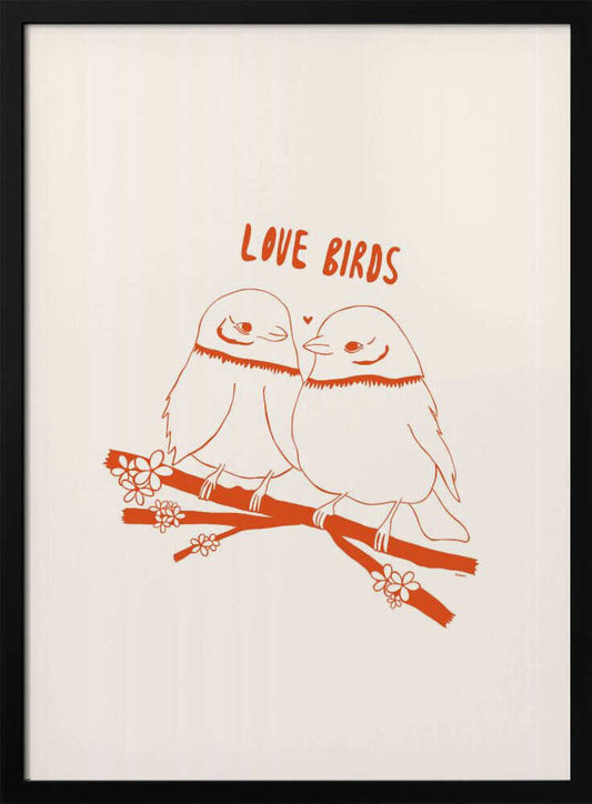 A framed art print featuring a minimalist, reddish-orange illustration on a cream background. Two cartoonish, plump birds sit close together on a flowering branch, looking at each other affectionately. Above them, the text 'LOVE BIRDS' is written in a playful, rounded font. Decor