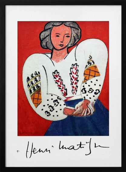 A framed art print of Henri Matisse's 'La Blouse Roumaine' (The Romanian Blouse). The painting depicts a woman with dark, styled hair against a vibrant solid red background. She is wearing a voluminous white blouse with puffy, intricately decorated sleeves and a dark blue skirt. Her hands are clasped in front of her. Below the image is the signature 'Henri Matisse'. Wall Art