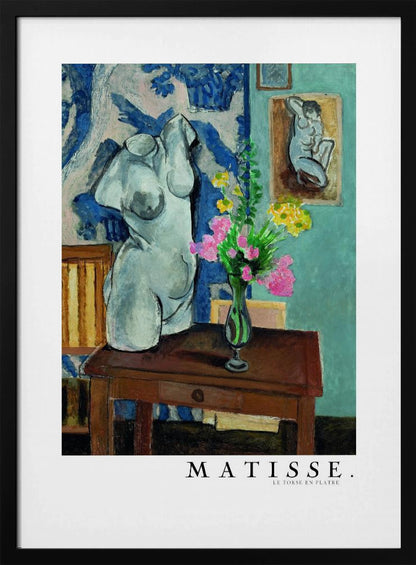 A framed art print of Henri Matisse's painting 'Le Torse en Plâtre'. The still life features a white plaster female torso sculpture next to a dark brown wooden table with a vase of pink and yellow flowers. The background consists of a blue and white patterned tapestry and a teal wall with a small framed nude drawing. Print