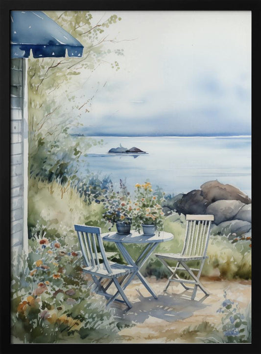 A watercolor painting of a tranquil coastal scene. A light blue bistro table and two matching chairs sit in a lush garden filled with flowers, overlooking a calm body of water. In the distance, a small island is visible under a soft, hazy sky. Part of a house with a blue awning can be seen on the left. Print