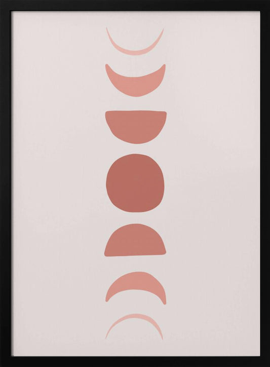 A minimalist art print in a black frame, featuring a vertical column of terracotta-colored shapes that represent the phases of the moon, from waxing crescent to full moon and back to waning crescent, set against a pale pink background. Wall Art