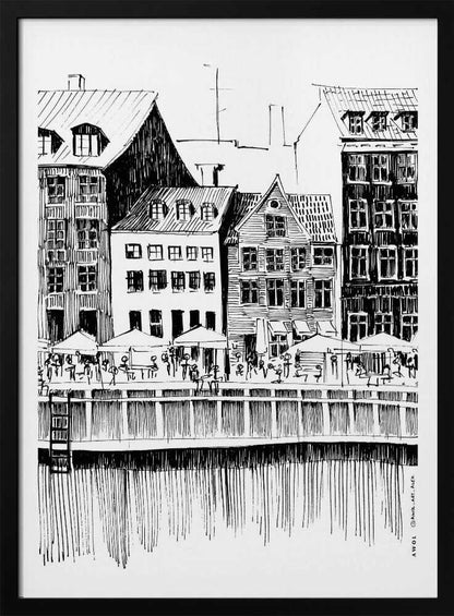 A black and white ink line drawing of a charming European city scene along a canal. Tall, narrow buildings with gabled roofs line the waterfront, in front of which is a bustling pier with outdoor cafes filled with people under umbrellas. The water's reflection is illustrated with simple vertical lines. The artwork is framed in black. Wall Art