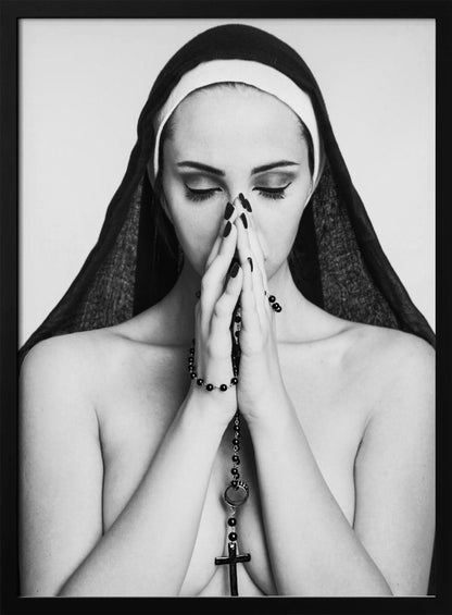 A black and white portrait of a woman with dramatic eye makeup wearing a nun's habit. Her eyes are closed and her hands are clasped in front of her face in prayer, holding a black rosary. Her shoulders are bare, creating a stark contrast. Artwork