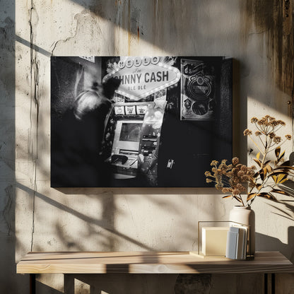 A grainy, black and white photograph of a person blurred by motion standing in front of a Johnny Cash themed slot machine. A lit marquee sign above the machine reads "HELLO I'm JOHNNY CASH OLÉ OLÉ". The setting appears to be a dark bar or casino. Wall Art