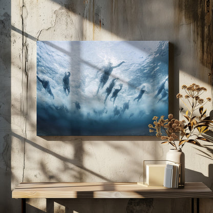 An underwater photograph looking up at a group of swimmers competing in a race. Their bodies are silhouetted against the bright surface of the turbulent blue water, captured mid-motion amidst a flurry of bubbles and foam. Print