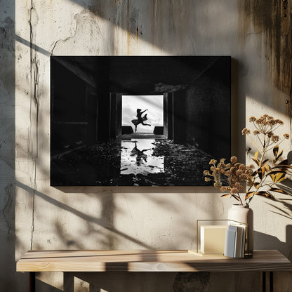 A dramatic black and white photo of a silhouetted dancer leaping in a bright doorway, viewed from inside a dark, derelict building. The dancer's reflection is captured in a puddle on the rubble-strewn floor. Poster