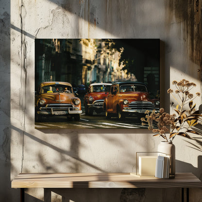 Three vintage American cars drive down a sunlit city street. The foreground features an orange taxi, with a red car and another orange vehicle behind it, all under the warm glow of late afternoon light casting long shadows. Print