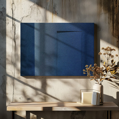 An abstract geometric artwork featuring textured panels in various shades of deep and dusty blue. The composition is divided into vertical sections, with a central rectangular shape that appears slightly recessed, creating a strong shadow line at its top edge. The piece is enclosed in a simple, brushed silver frame. Wall Art