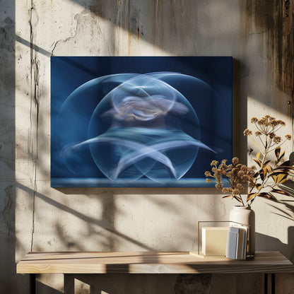 An abstract long-exposure photograph of a spinning dancer, creating ethereal, intersecting trails of blue and white light that form a glowing, orb-like shape against a deep blue background. The image is presented within a silver frame. Poster