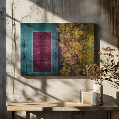 An aerial top-down photograph of a red and green tennis court covered in fallen leaves, adjacent to a dense grove of trees with vibrant yellow and gold autumn foliage, all enclosed in a silver frame. Wall Art