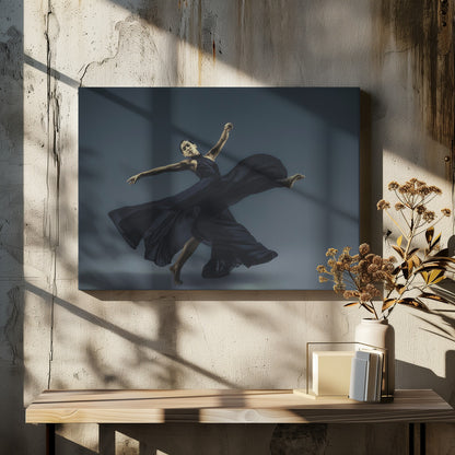 A framed photograph of a graceful female dancer in a dramatic pose, her long, dark blue, flowing dress billowing around her against a muted blue-gray studio background. Wall Art