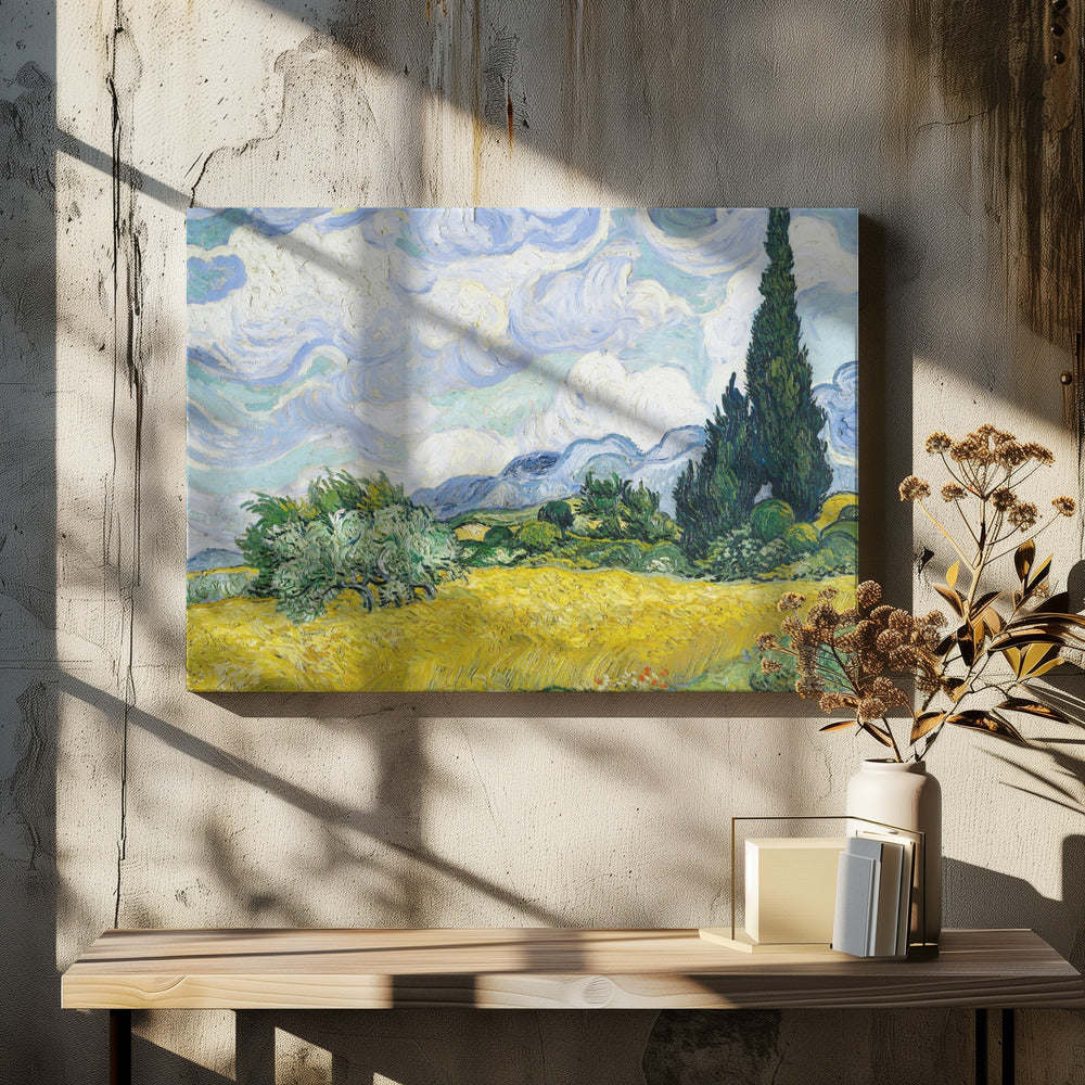 A framed print of Vincent van Gogh's painting 'Wheat Field with Cypresses.' The artwork depicts a vibrant golden wheat field under a dynamic sky filled with swirling white and blue clouds. A tall, dark green cypress tree dominates the right side, with rolling green hills and distant blue mountains in the background. Decor