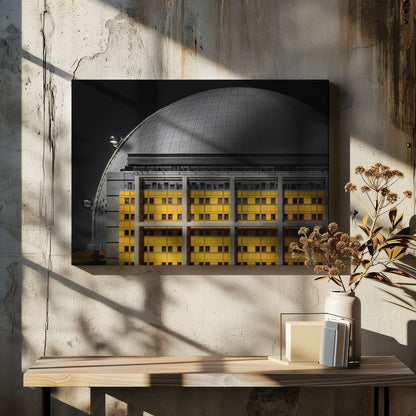A framed architectural photograph with selective color, featuring a bright yellow building in the foreground against a monochrome background of a large grey dome structure under a black sky. Wall Art