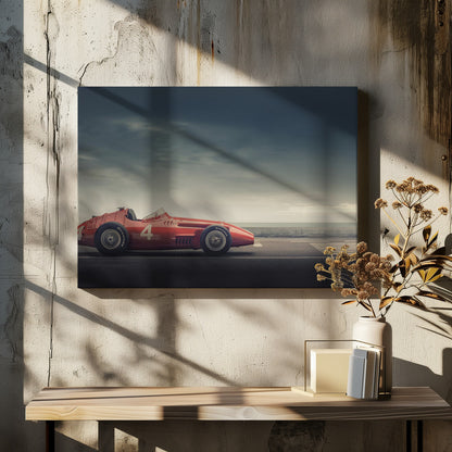 A side profile of a vintage red single-seater race car with the number 4 painted on it, parked on a seaside road under a dramatic, cloudy sky. The image has a muted, nostalgic color palette and is shown within a silver frame. Decor