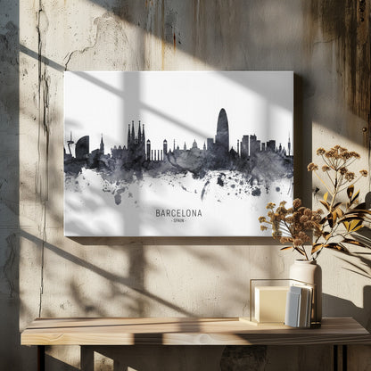 A framed black and white watercolor silhouette of the Barcelona, Spain skyline. Famous landmarks like the Sagrada Familia and Torre Glòries are visible. The word 'BARCELONA' is printed below the cityscape against a clean white background. Poster