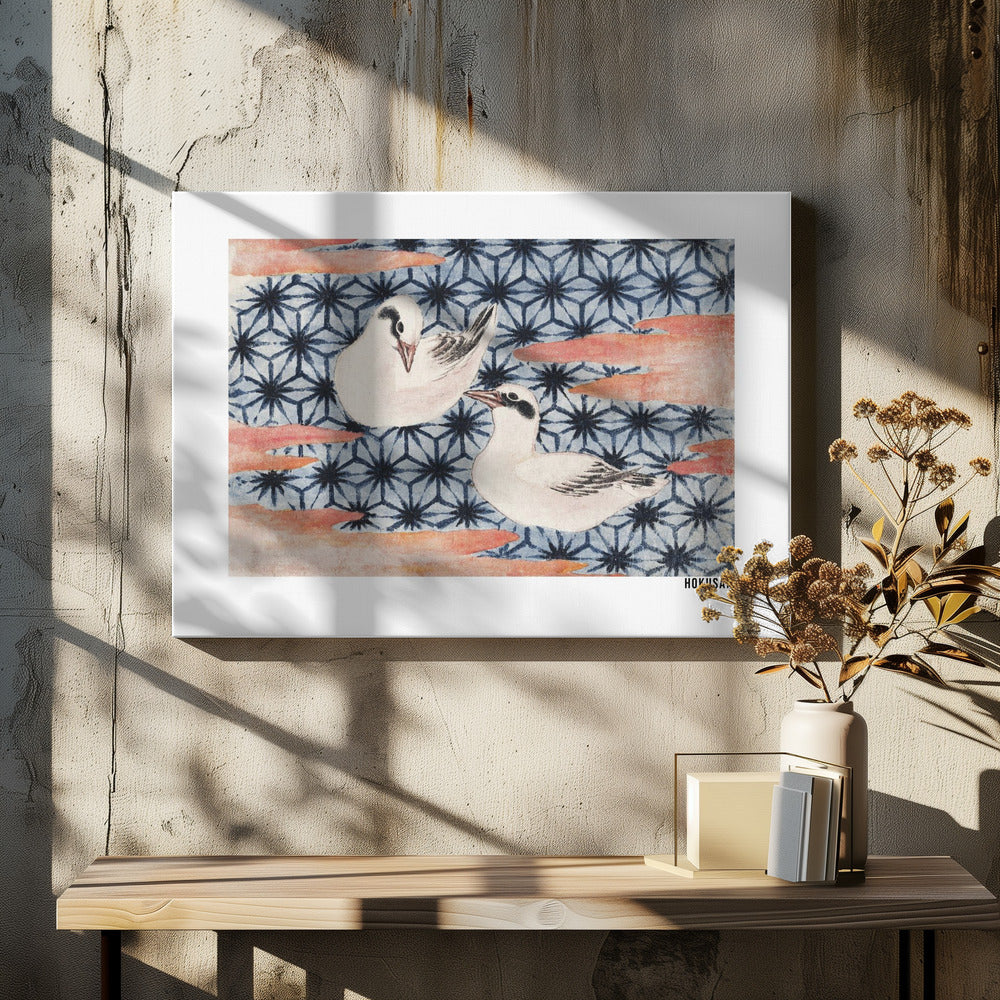 A classic Japanese woodblock print by Hokusai featuring two white birds with black eye markings resting on a background of a traditional blue Asanoha geometric pattern. Soft, reddish-orange cloud-like shapes float across the scene. Print