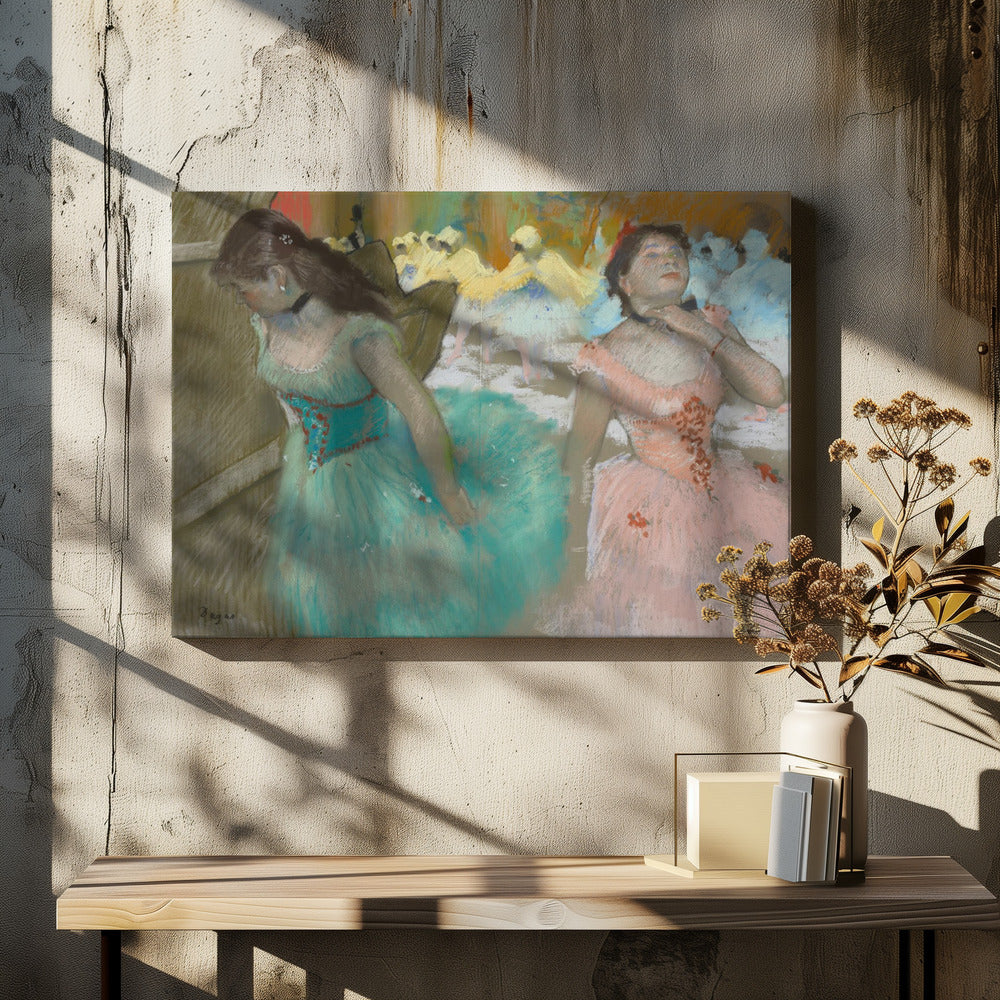 A framed pastel artwork by Edgar Degas depicting several ballerinas. In the foreground, a ballerina in a turquoise tutu looks down, while another in a pink tutu adjusts her collar with her eyes closed. In the background, more dancers in yellow and white are blurred on a stage. Wall Art
