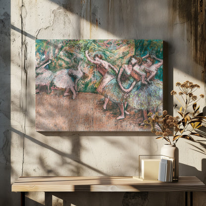 An Impressionist painting by Edgar Degas of ballet dancers on a stage against a green and orange backdrop. The dancers, in various poses, wear tutus in shades of white, pink, and light green. The artwork is framed in a simple silver frame. Artwork