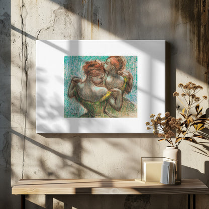 A framed pastel drawing by Edgar Degas, 'Two Dancers', depicting two ballerinas from behind. One dancer in a green dress with a yellow strap adjusts her costume, while another stands closely behind her against a textured turquoise background. The style is Impressionistic, capturing a candid moment. Artwork