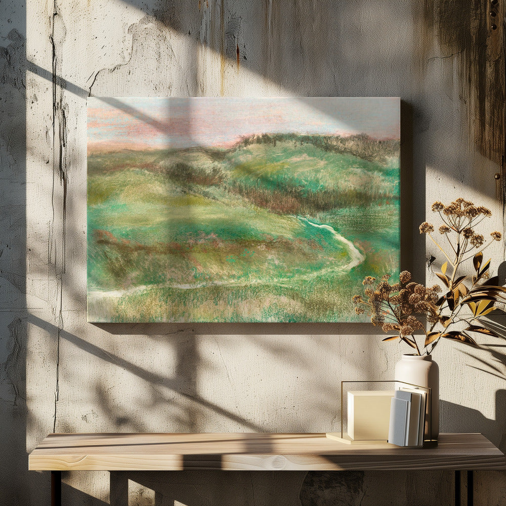 A framed, impressionistic pastel drawing of a rolling green landscape with a winding path or stream. The hills are a mix of vibrant and muted greens with earthy brown tones, under a soft pink and pale blue sky. The texture is soft and painterly, and the artwork is enclosed in a simple silver frame. Artwork