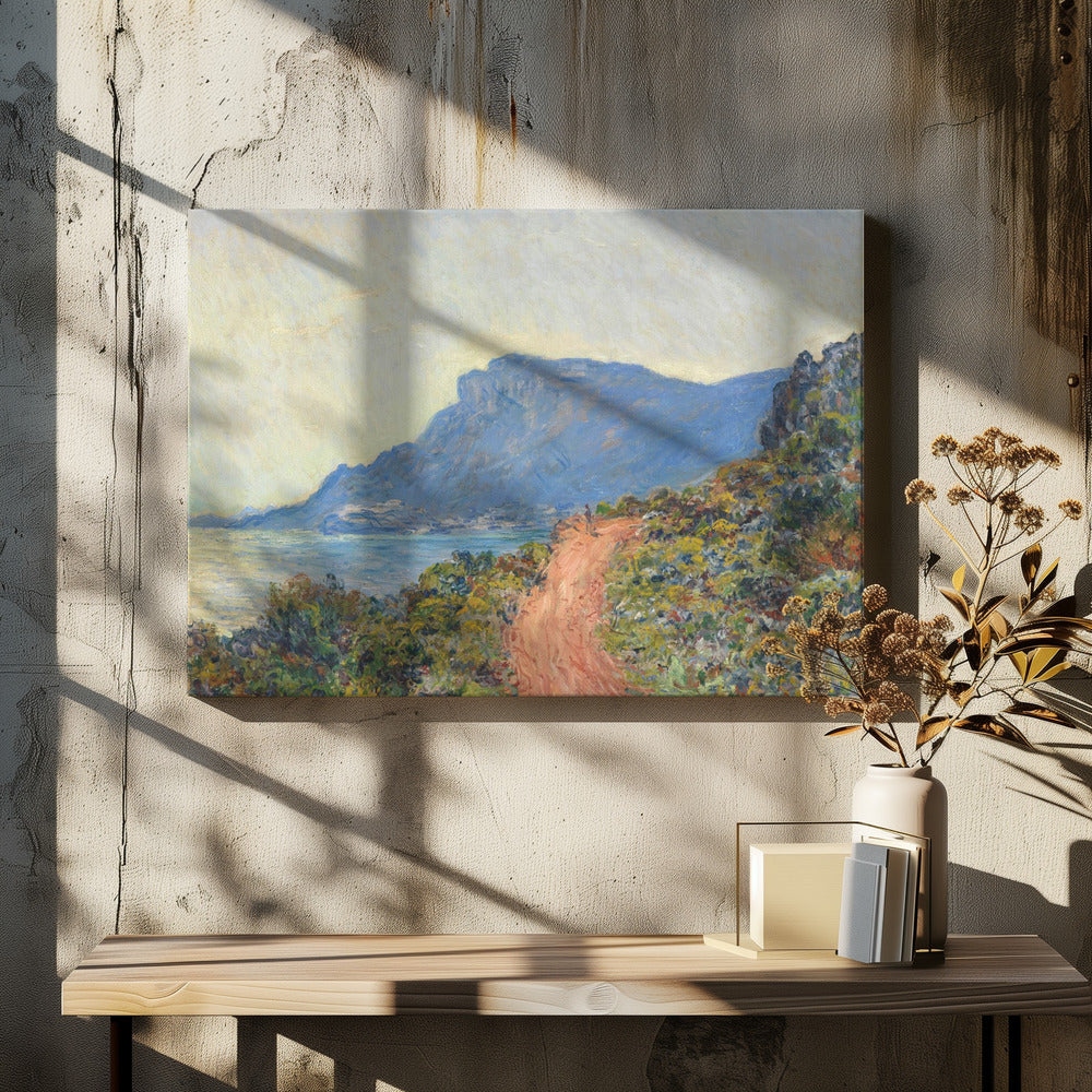 An Impressionist painting by Claude Monet titled 'Cap Martin, near Menton', depicting a sunlit coastal scene. A reddish-brown path winds along a vibrant, brush-covered cliff in the foreground, overlooking the blue Mediterranean Sea. A large, hazy blue mountain dominates the background under a pale yellow sky. Decor