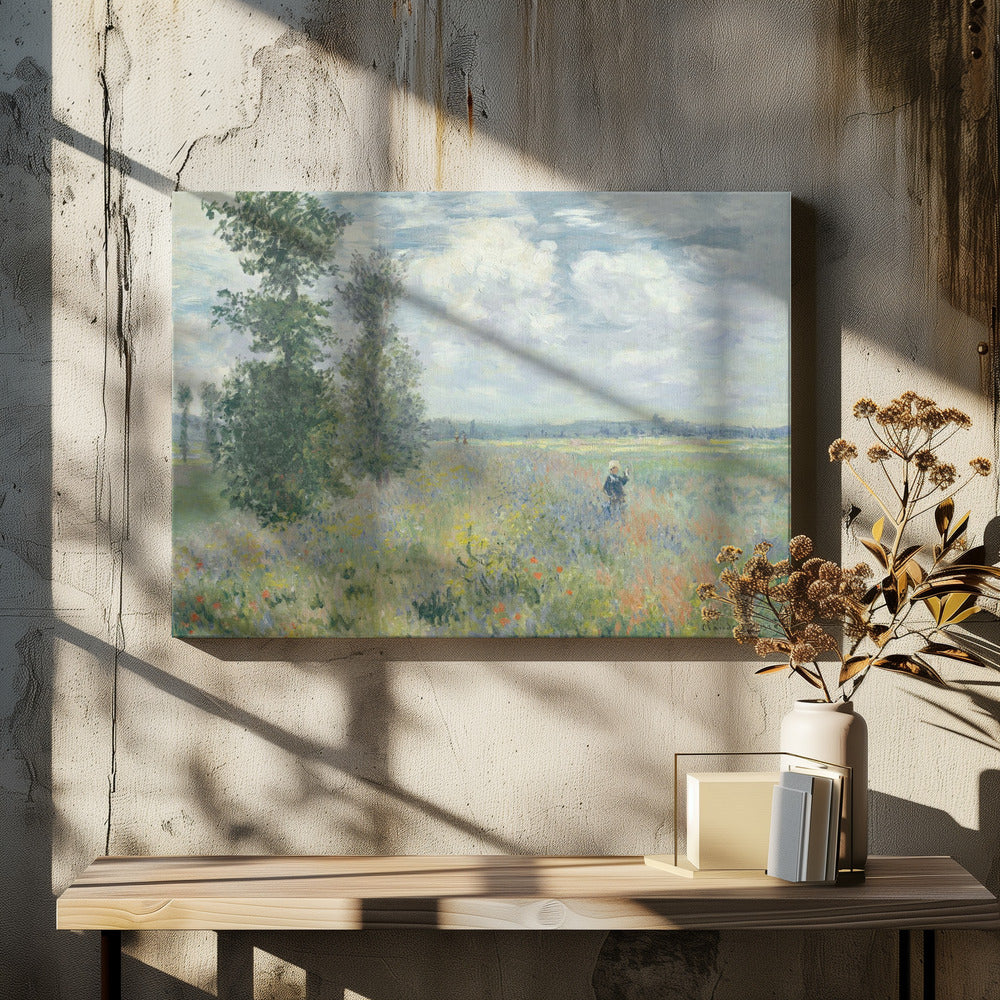 An impressionist painting by Claude Monet titled 'Poppy Field near Vétheuil', depicting a vast field of green grass dotted with red, yellow, and purple wildflowers. A figure in a white bonnet stands in the field to the right. Tall green trees are on the left, under a blue sky with fluffy white clouds. The entire scene is presented within a modern silver frame. Wall Art