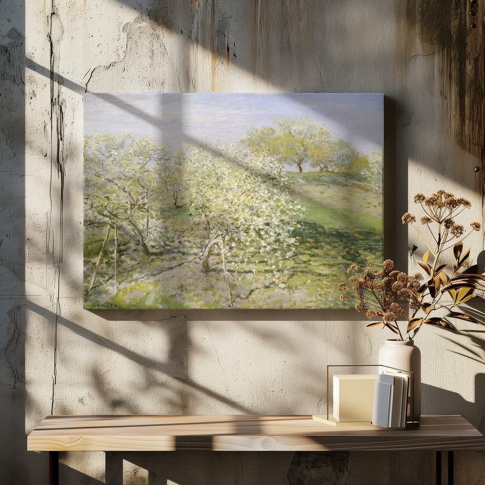 An impressionist painting of an orchard in full bloom, with white and yellow blossoms covering the trees. The orchard is set on a rolling green hillside under a pale, hazy sky, with soft shadows cast on the grass. The artwork is presented in a silver frame. Wall Art