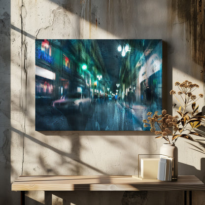 An abstract, moody artwork of a busy city street at night, viewed as if through a rainy window or with motion blur. The scene is dominated by shades of deep blue and vibrant green, with glowing streetlights and neon signs casting reflections on the wet pavement. Silhouettes of people walk down the street, and a car is partially visible on the left. The entire composition has a dynamic, dreamlike quality and is presented in a silver frame. Poster
