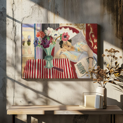 A Fauvist-style painting by Henri Matisse depicting a woman in a colorful blouse reclining with a book. Beside her is a table with a bold red-and-white striped cloth holding a light green vase with red, purple, and white anemone flowers. Print