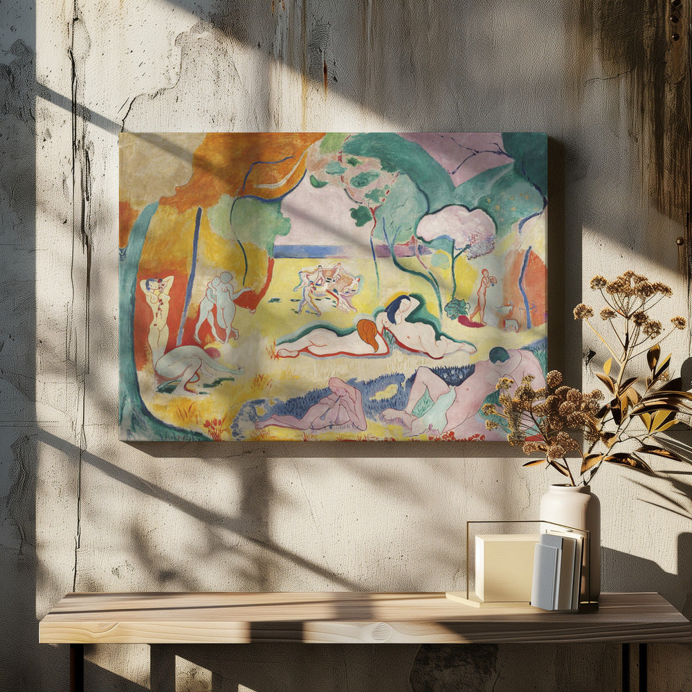 A framed print of Henri Matisse's Fauvist painting, 'Le bonheur de vivre' (The Joy of Life). It shows a vibrant, colorful landscape with numerous nude figures relaxing, dancing, and playing music. The scene uses unnaturalistic colors like yellow earth, orange and green trees, and a pink sky to evoke a sense of idyllic joy. Decor
