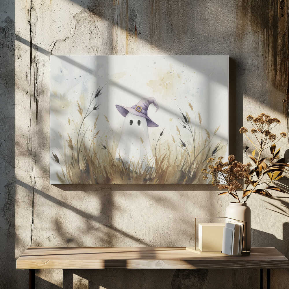 A whimsical watercolor painting of a cute white ghost wearing a purple witch's hat. The ghost is standing in a field of tall, dry brown and beige grasses against a light, splotchy background, all within a silver frame. Artwork