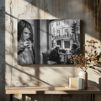 A framed, black and white photograph capturing a scene of juxtaposition. On the left, a large poster shows a glamorous young woman holding a coffee cup. On the right, seen through a cafe window, an elderly couple sits at a small table, also with coffee cups, engaged in conversation against a backdrop of an old European city street. Poster