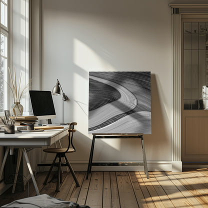 A framed black and white abstract artwork featuring a dynamic composition of flowing, wave-like forms created from dense, parallel lines. Lighter-toned curves sweep across the canvas, overlapping darker areas and creating a sense of depth, texture, and movement. Decor