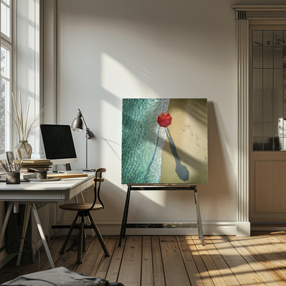 An aerial photograph of a serene beach scene, featuring a vibrant red umbrella on the golden sand next to the clear turquoise ocean. Gentle white waves lap the shore, and a long shadow from the umbrella stretches across the sand, where a trail of footprints leads away. Poster