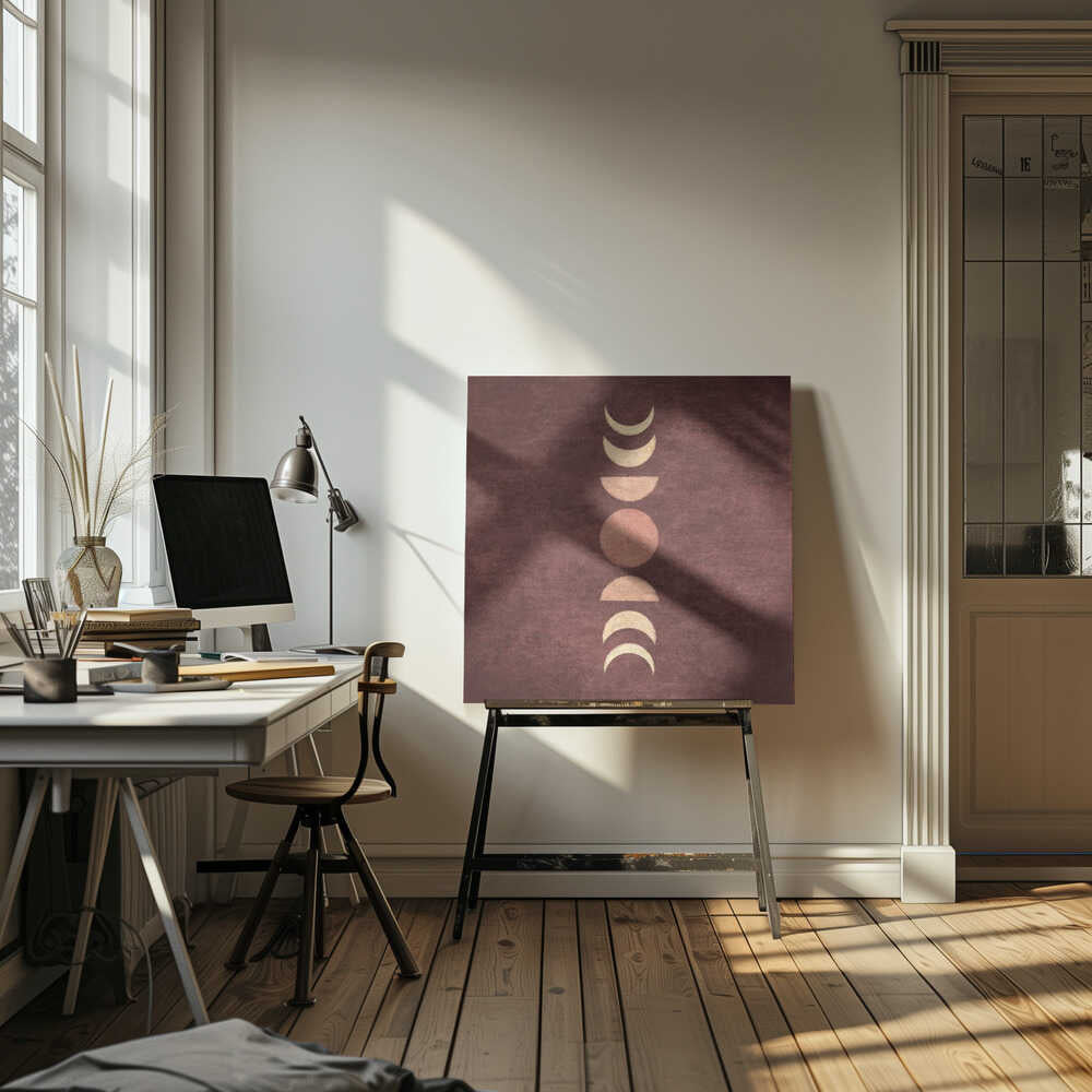 A minimalist piece of framed art showing the phases of the moon arranged vertically against a textured, deep maroon background. The moon shapes are colored in shades of cream and dusty rose, with the full moon in the center. Print