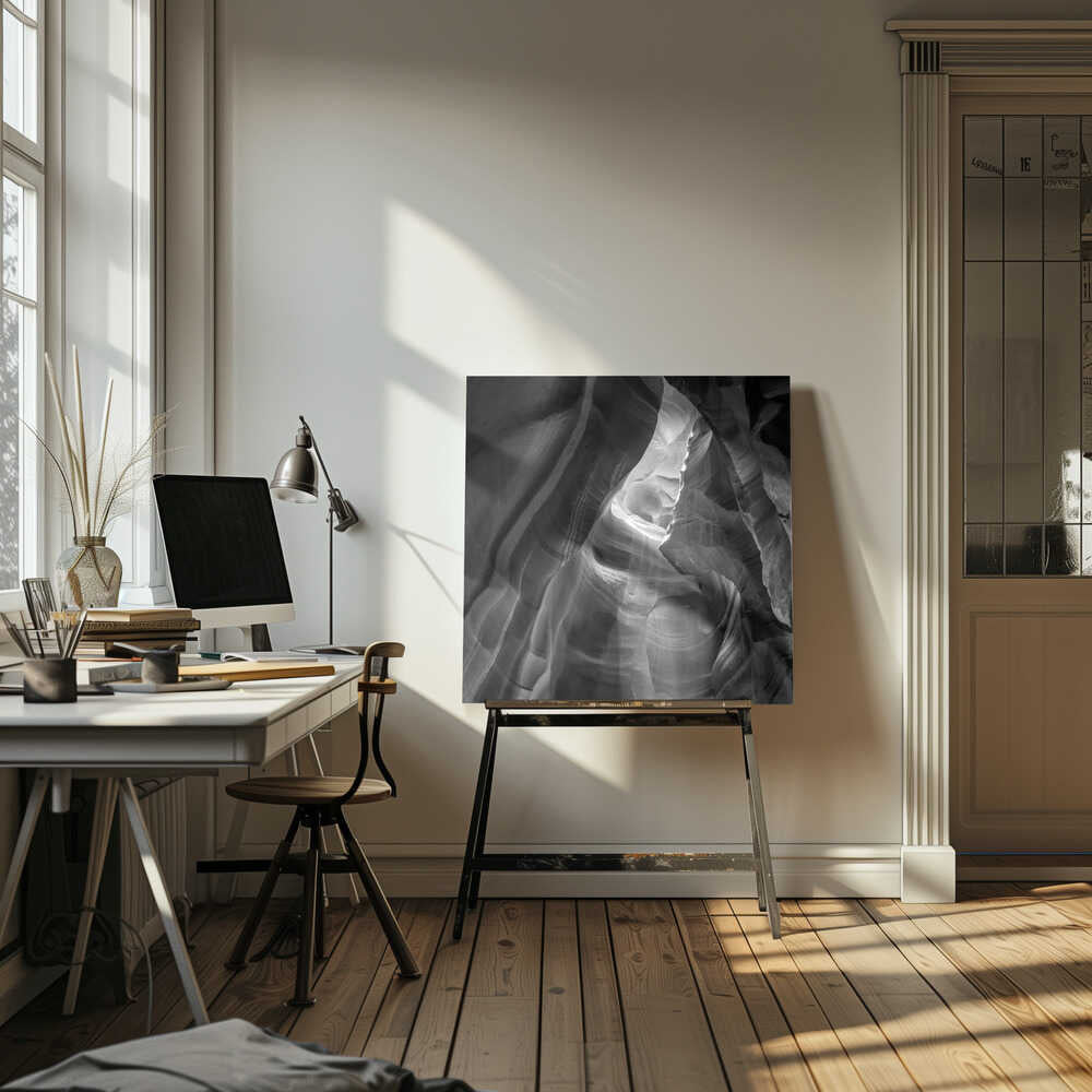 Black and white photo of light in a narrow slot canyon, highlighting smooth, layered rock formations. Nature wall art.