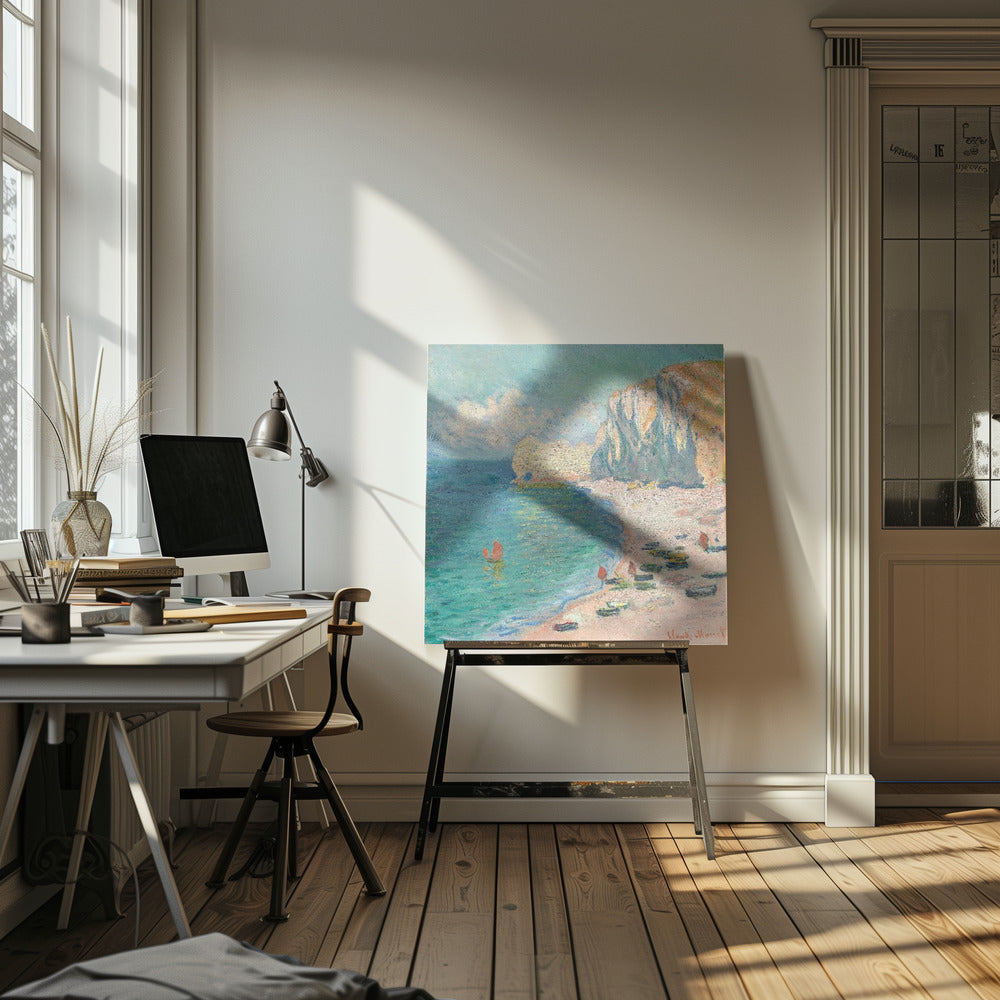 An impressionist painting by Claude Monet depicting the beach at Étretat, France, enclosed in a light wood frame. The artwork shows tall, light-colored cliffs on the right, a sandy beach with small boats, and vibrant turquoise water with a few red-sailed boats. The sky is partly cloudy. Decor