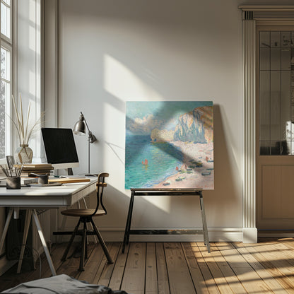 An impressionist painting by Claude Monet depicting the beach at Étretat, France, enclosed in a light wood frame. The artwork shows tall, light-colored cliffs on the right, a sandy beach with small boats, and vibrant turquoise water with a few red-sailed boats. The sky is partly cloudy. Decor