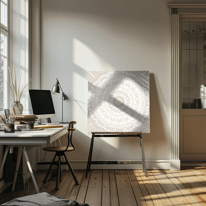 A framed square artwork featuring a detailed mandala design in neutral tones. The intricate pattern consists of concentric circles with geometric shapes like 'X's and chevrons, rendered in shades of beige and taupe on a white background, all enclosed in a light-colored wooden frame. Decor