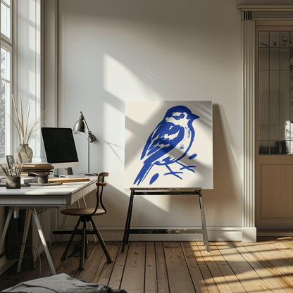 A stylized art print of a small bird, possibly a sparrow, rendered in bold cobalt blue ink with expressive brushstrokes. The bird is set against a solid cream background and enclosed in a light wood frame. Print