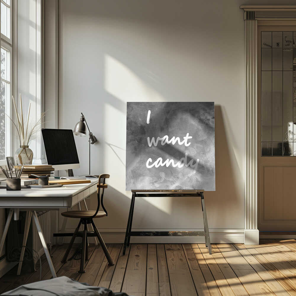 A framed typography art piece with a light brown wood frame. It features the phrase 'I want candy' in a white, handwritten script against a textured, dark gray and white chalkboard-style background. Wall Art