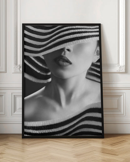 A mysterious black and white close-up portrait of a woman wearing a large, floppy hat with bold black and white stripes. The hat's brim covers her eyes, revealing only her nose, full lips, and chin, creating an elegant and enigmatic look. Decor