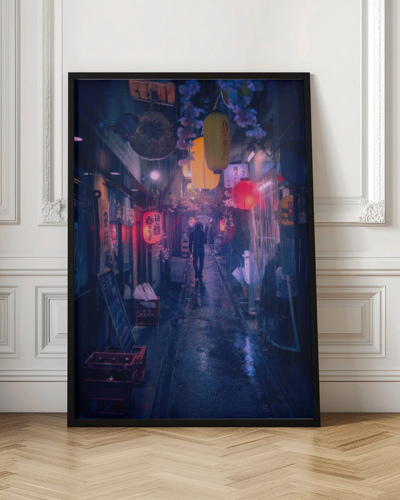 A lone figure walks down a narrow, rain-slicked Japanese alley at night. Colorful paper lanterns hang overhead, casting warm orange and red light that reflects on the wet ground, contrasting with the cool blue tones of the evening. Wall Art