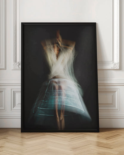 An ethereal, long-exposure photograph of a dancing figure against a dark gray background. The motion blur creates a ghostly effect, with white, gauzy fabric swirling around the upper body. The figure wears a transparent crinoline hoop skirt, revealing her legs and feet. Artwork
