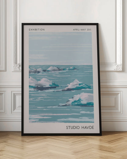 A framed exhibition poster from 'Studio Havde' dated April-May 2015. The artwork is a stylized, painterly seascape featuring white clouds or icebergs floating on a calm, teal-blue ocean under a pale sky. The piece is set within a wide, off-white border and a simple black frame. Wall Art