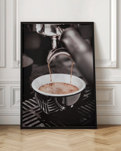 A close-up, desaturated photograph of an espresso machine pouring two streams of rich brown coffee from a chrome portafilter into an ornate black and white cup. Poster