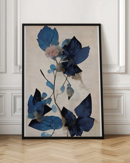 An abstract botanical artwork featuring large, angular leaves in various shades of deep and light blue. A single delicate pink flower blooms on a thin, dark stem against a textured, light cream background. The piece is displayed in a thin black frame. Artwork
