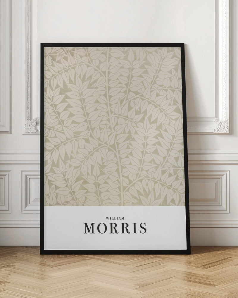 A framed art print by William Morris featuring a dense, repeating pattern of stylized leaves and branches in cream and light sage green. A white border at the bottom displays 'WILLIAM MORRIS' in a black serif font. Artwork