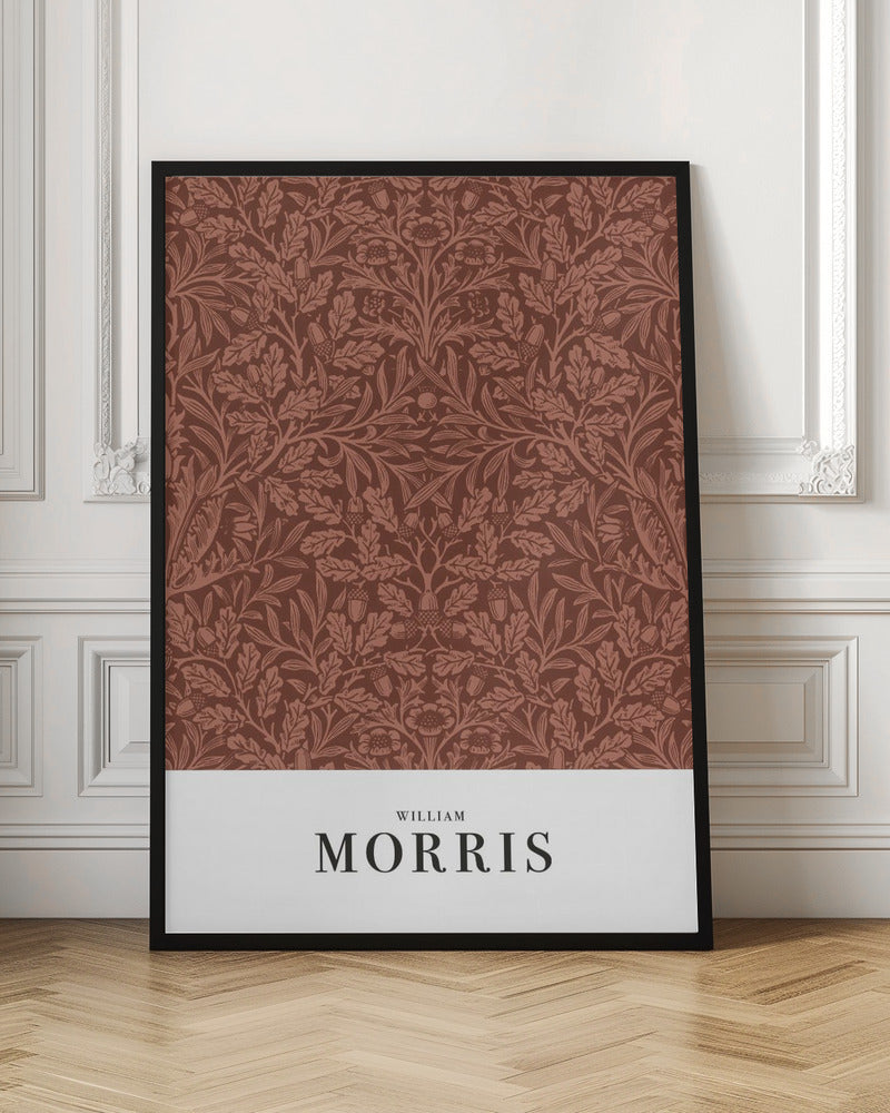A framed art print of a classic William Morris design. The intricate, symmetrical pattern features terracotta-colored oak leaves, acorns, and stylized flowers on a rich brown background. Below the pattern is a white section with the name 'WILLIAM MORRIS' in black serif font. Print